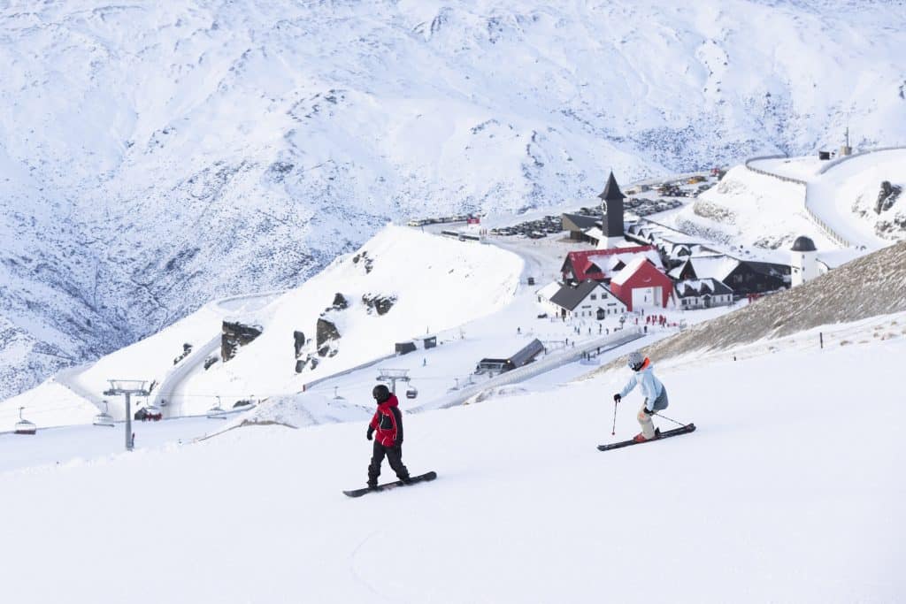 Skiers on the slopes with Cardrona Alpine Resort in the background